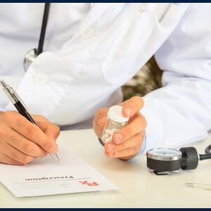 67327979 - doctor writing a perscription on his desk