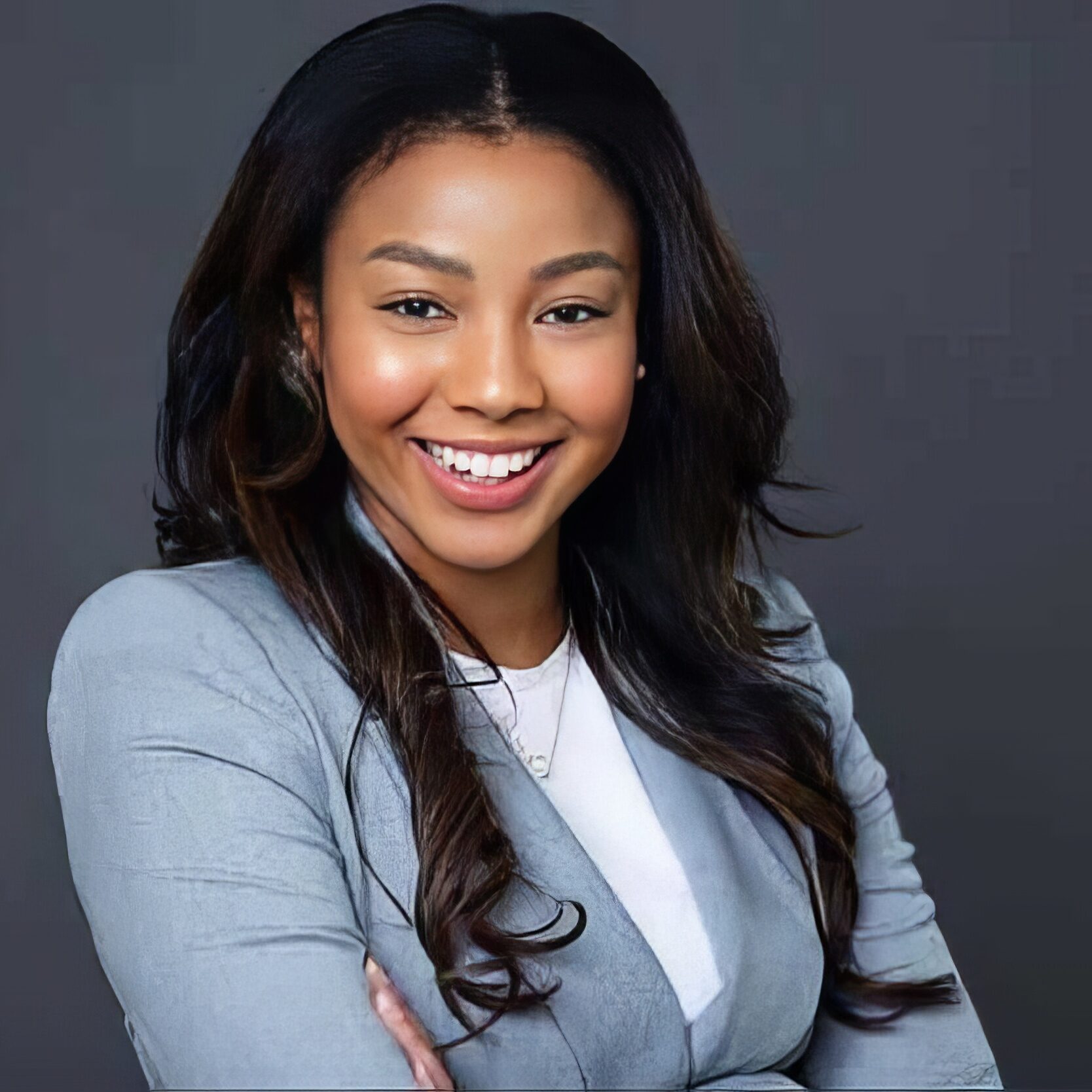 Meet Jordyn Norde, PharmD RX Outreach Dellwood Community Pharmacy Missouri Nonprofit Charity Pharmacy A photo of Dellwood Community Pharmacy's Pharmacist-in-Charge, Jordyn Nordè, PharmD. She's wearing a grey blazer, crossing her arms, and smiling warmly.